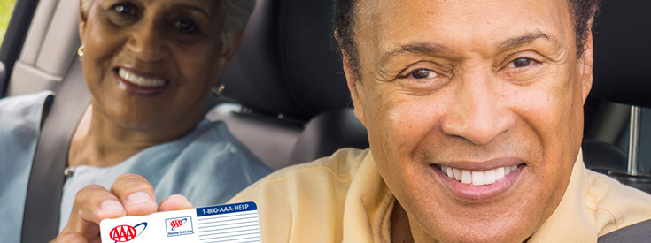 Senior driver holds AAA card up Senior driver holds AAA card up